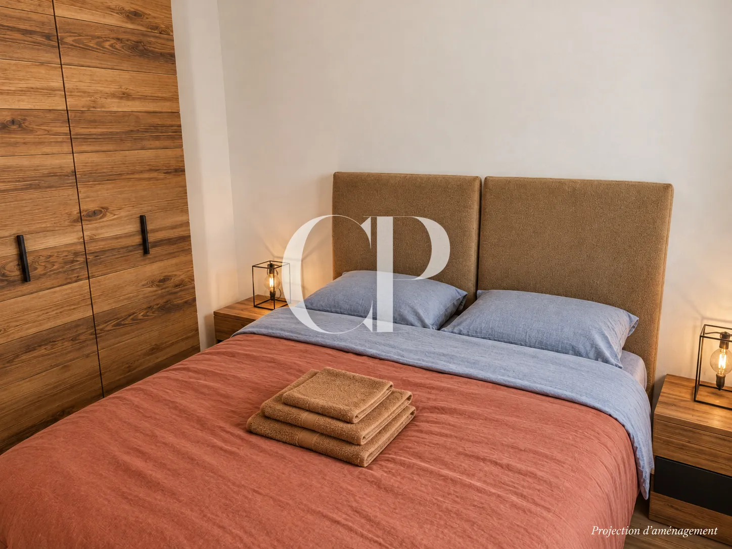 A bedroom, linen headboard and full-height wardrobe