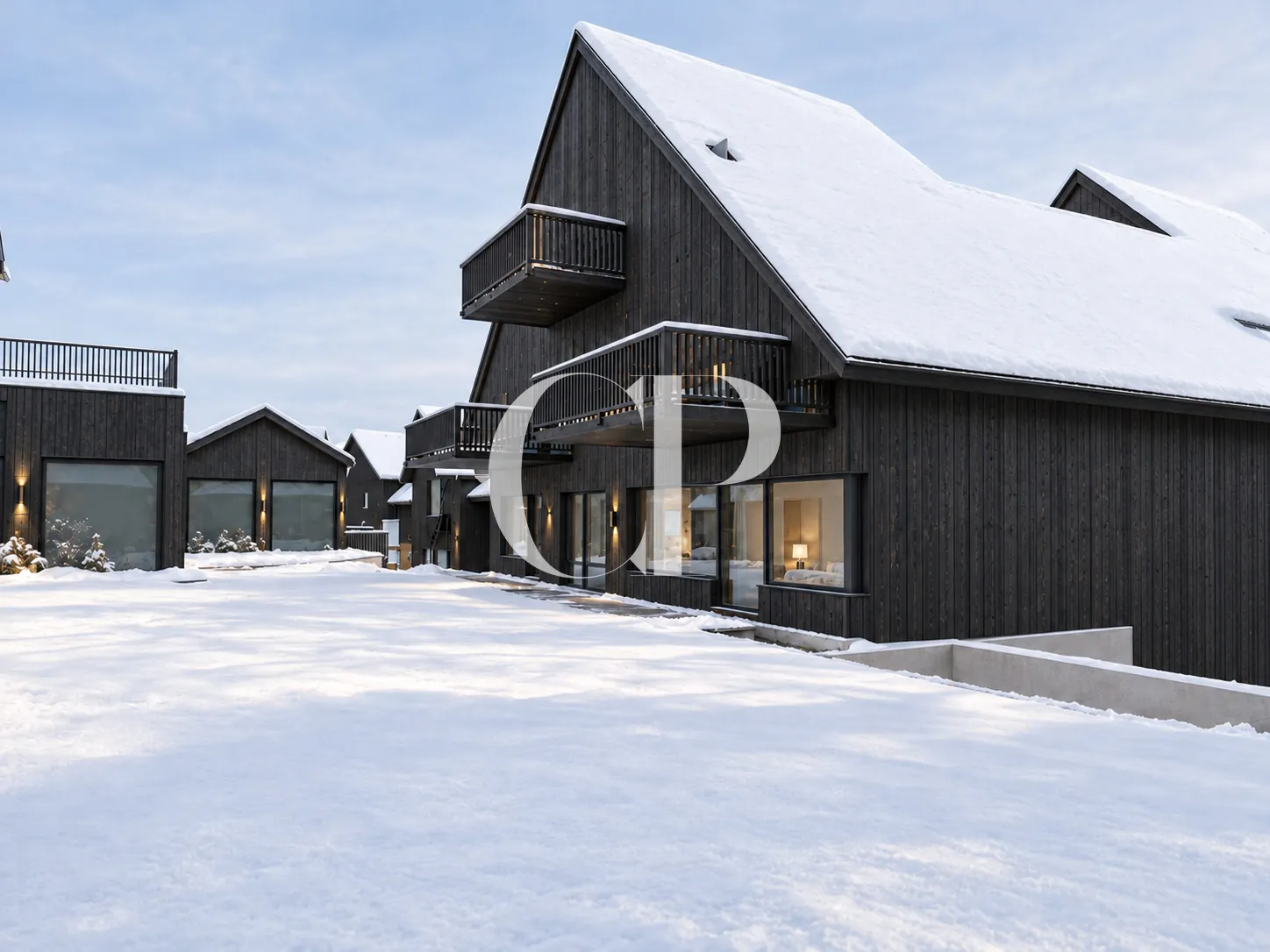 The hamlet under snow, its charred-timber façades